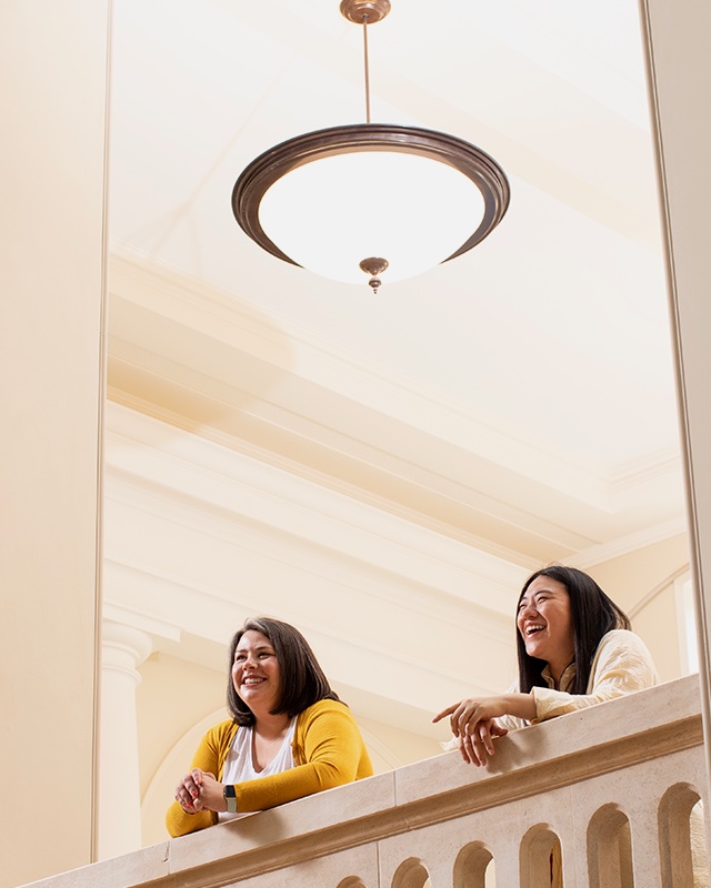 Two people at the RCM looking out over the new atrium